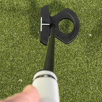 L.A.B. Golf mallet putter behind a ball on a putting green