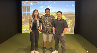 Three people posing in a Clubhouse Hawaii simulator bay